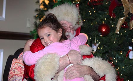 Kiddi Kollege Girl Hugging Santa