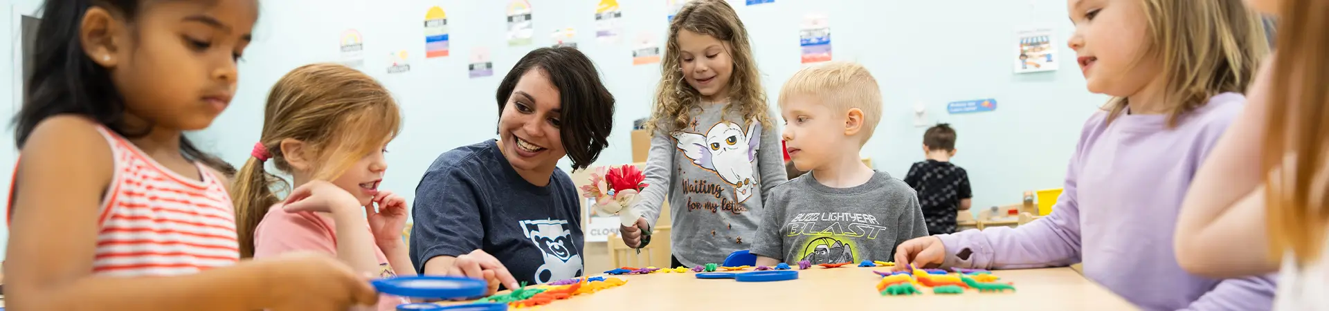 Kids In Classroom Playing And Learning With Teacher