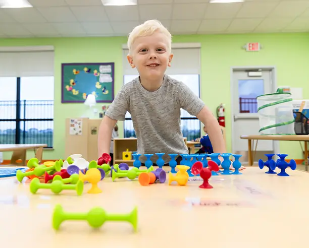 Young Kid Playing And Learning With Toys
