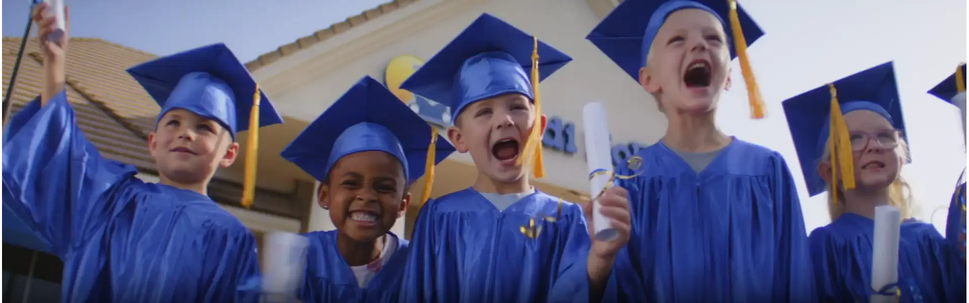 Kids Wearing Graduation Cap And Gown