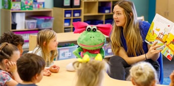 Teacher Reading Story Puppet Preschool Class