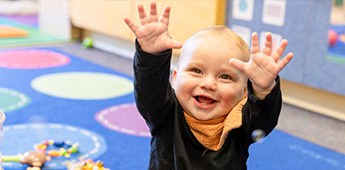 Happy Baby Raising Hands Preschool Play Area