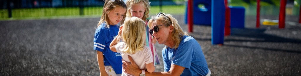 A preschool teacher capturing a teachable moment with a child.